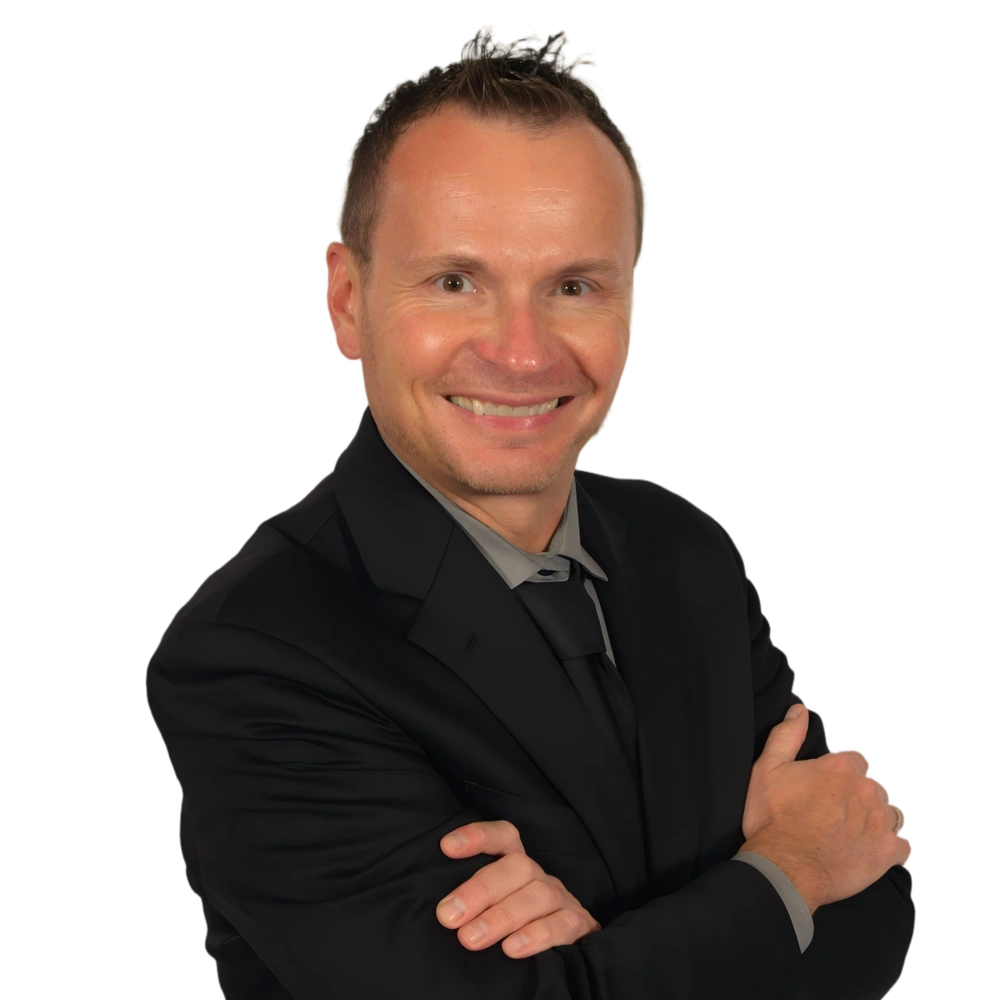 David Farr, Minneapolis magician, in a black suit with his arms folded